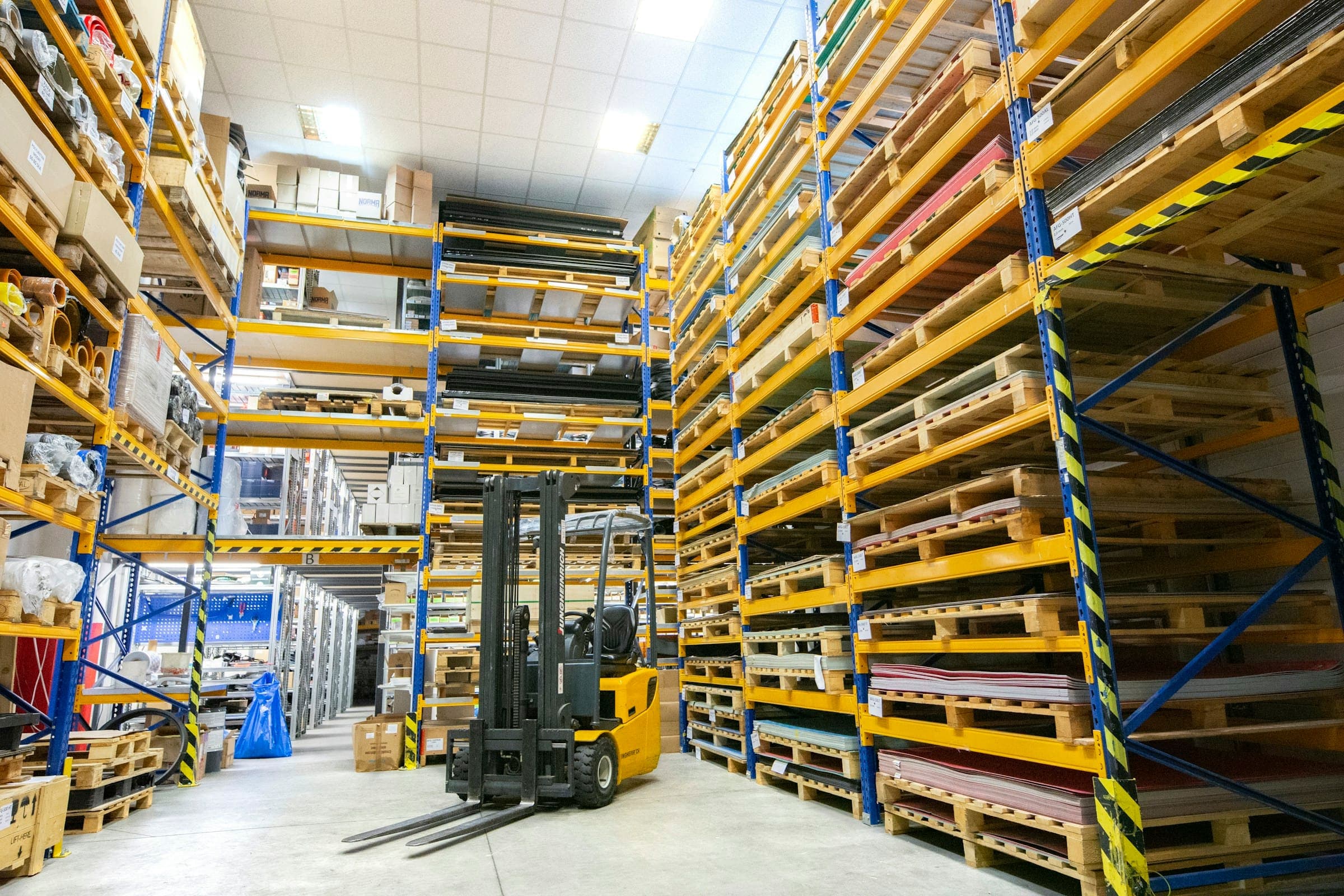 Wide interior view of a distribution warehouse with tall pallet racking